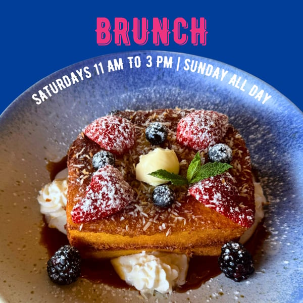 Neon Cactus brunch: French toast with berries, whipped cream, and syrup on a blue plate.